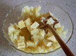 while the potato is still warm, mix in the butter and salt